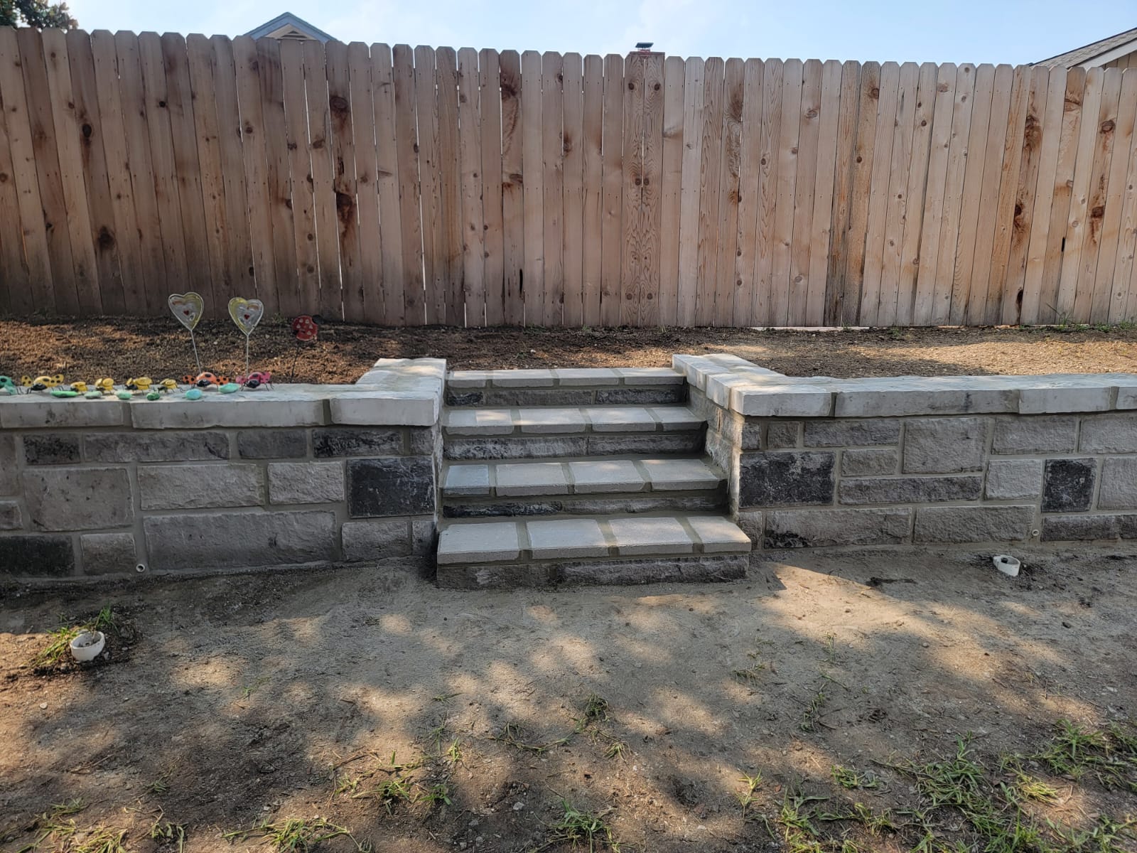 Backyard retaining wall with centered capstone steps