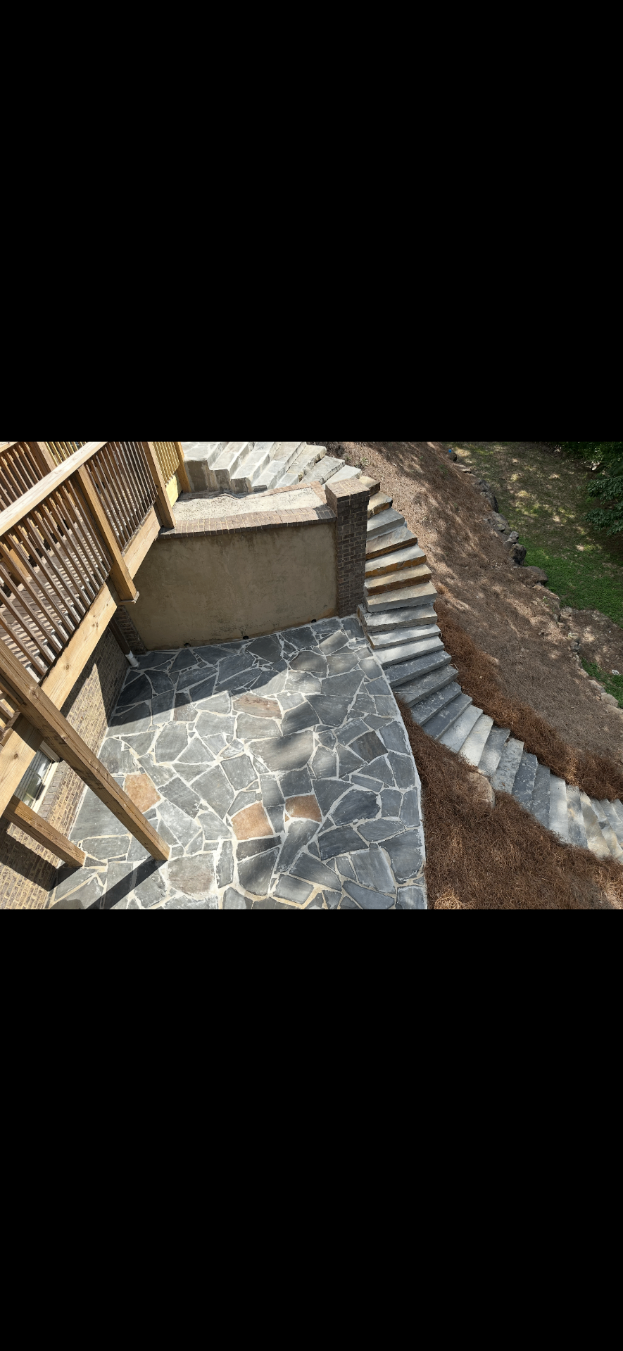 Multi-level stone stair and retaining wall project on a steep hillside